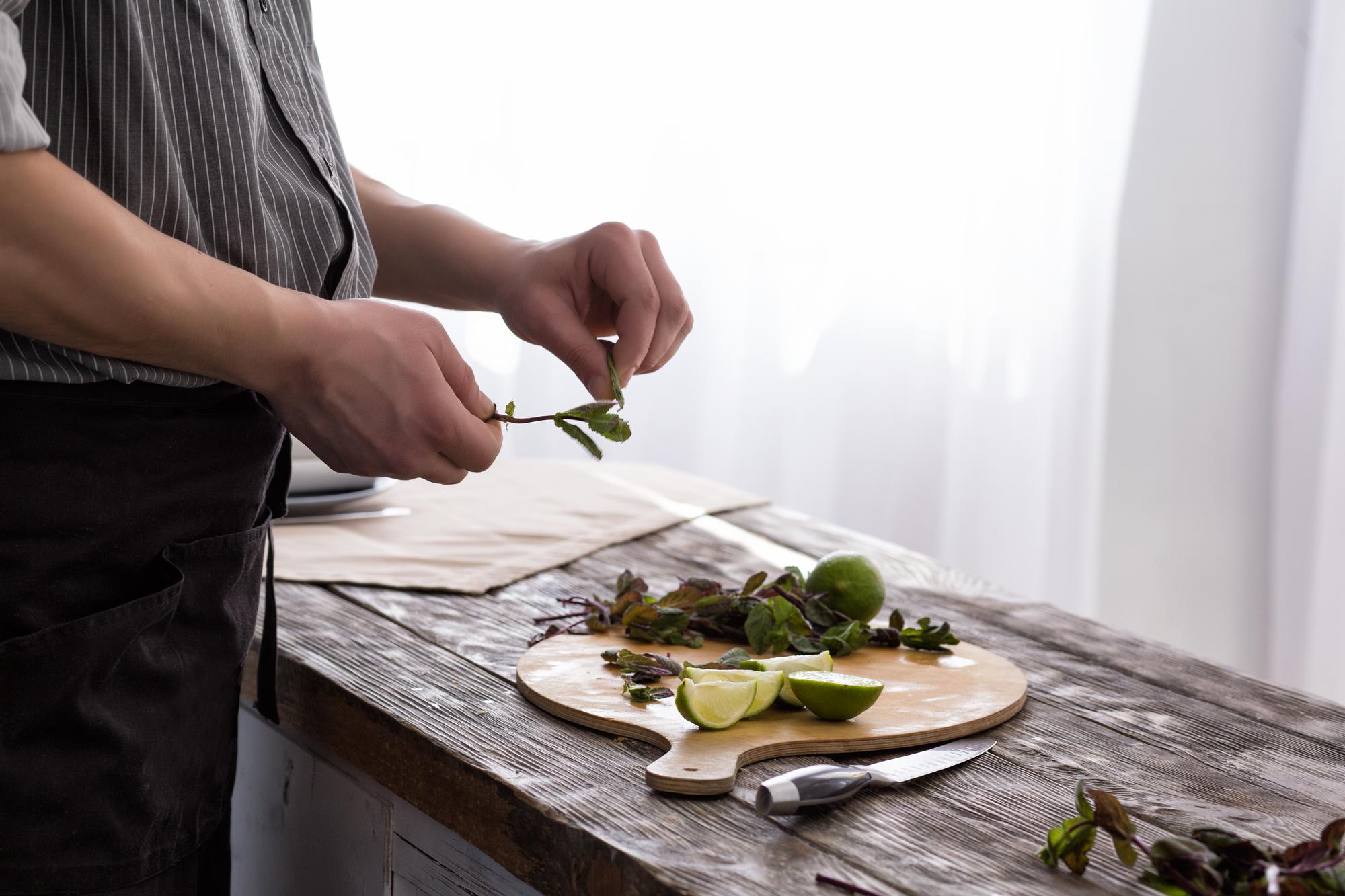 Chef preparing a rustic local dish on a wooden table